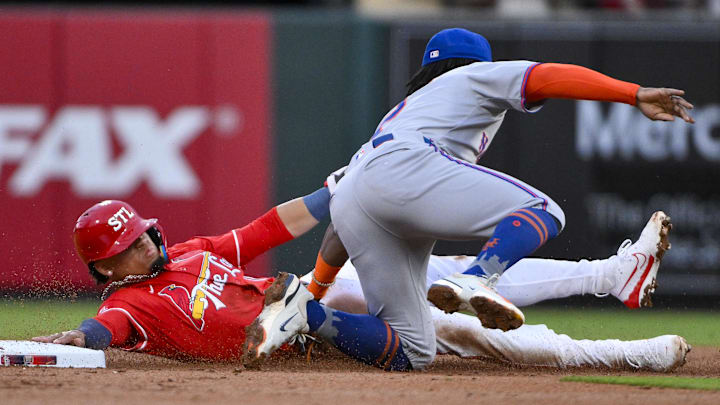 May 2, 2025; St. Louis, Missouri, USA;  St. Louis Cardinals shortstop Masyn Winn (0) is tagged out by New York Mets second baseman Luisangel Acuna (2) on a stolen base attempt during the first inning at Busch Stadium. Mandatory Credit: Jeff Curry-Imagn Images