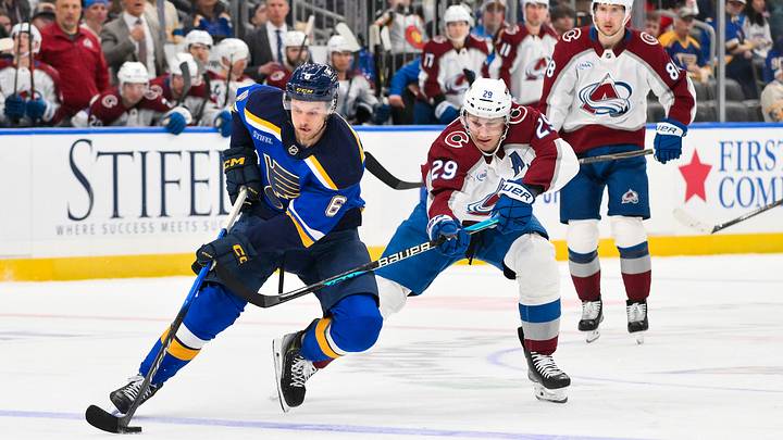 Apr 7, 2026; St. Louis, Missouri, USA; St. Louis Blues defenseman Philip Broberg (6) controls the puck as Colorado Avalanche center Nathan MacKinnon (29) defends during the second period at Enterprise Center. Mandatory Credit: Jeff Curry-Imagn Images