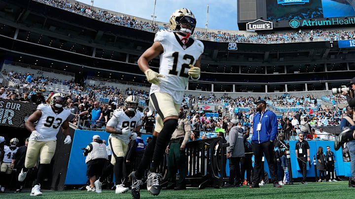 Nov 3, 2024; Charlotte, North Carolina, USA; New Orleans Saints wide receiver Chris Olave (12) runs on to the field before the game at Bank of America Stadium. Mandatory Credit: Bob Donnan-Imagn Images Nov 3, 2024; Charlotte, North Carolina, USA; New Orleans Saints wide receiver Chris Olave (12) runs on to the field before the game at Bank of America Stadium. Mandatory Credit: Bob Donnan-Imagn Images