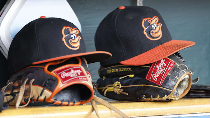 Apr 27, 2023; Detroit, Michigan, USA;  Baltimore Orioles hats and glove sits in dugout in the second inning against the Detroit Tigers at Comerica Park. Mandatory Credit: Rick Osentoski-Imagn Images