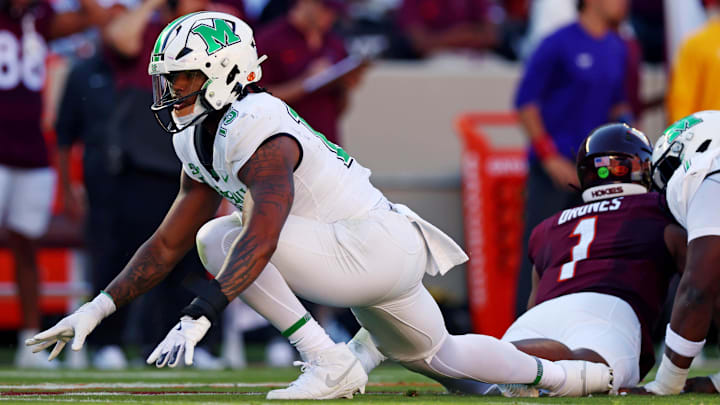 Sep 7, 2024; Blacksburg, Virginia, USA; Marshall Thundering Herd defensive lineman Mike Green (15) celebrates after sacking Virginia Tech Hokies quarterback Kyron Drones (1) during the first quarter at Lane Stadium. Mandatory Credit: Peter Casey-Imagn Images