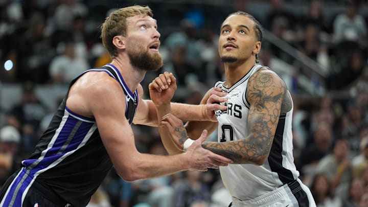 Nov 16, 2025; San Antonio, Texas, USA; Sacramento Kings forward Domantas Sabonis (11) an San Antonio Spurs forward Jeremy Sochan (10) battle for position in the first half at Frost Bank Center. Mandatory Credit: Daniel Dunn-Imagn Images