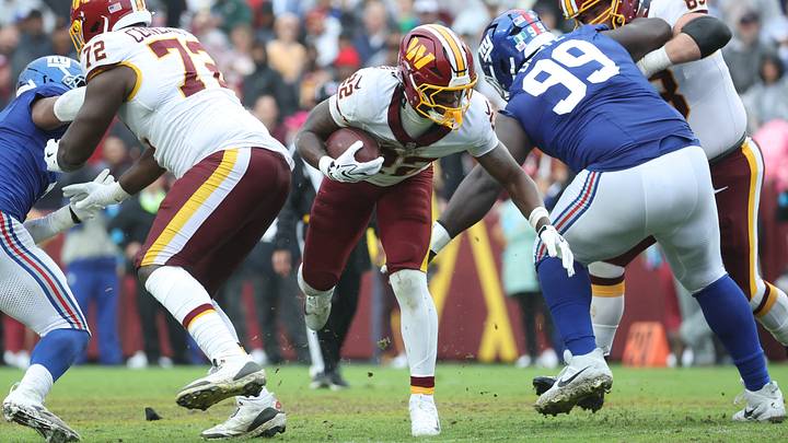 Oct 11, 2026; Landover, Maryland, USA; Washington Commanders running back Jacory Croskey-Merritt (22) runs the ball past New York Giants defensive tackle C.J. Okoye (99) during the third quarter at Northwest Stadium. Mandatory Credit: Amber Searls-Imagn Images Oct 11, 2026; Landover, Maryland, USA; Washington Commanders running back Jacory Croskey-Merritt (22) runs the ball past New York Giants defensive tackle C.J. Okoye (99) during the third quarter at Northwest Stadium. Mandatory Credit: Amber Searls-Imagn Images