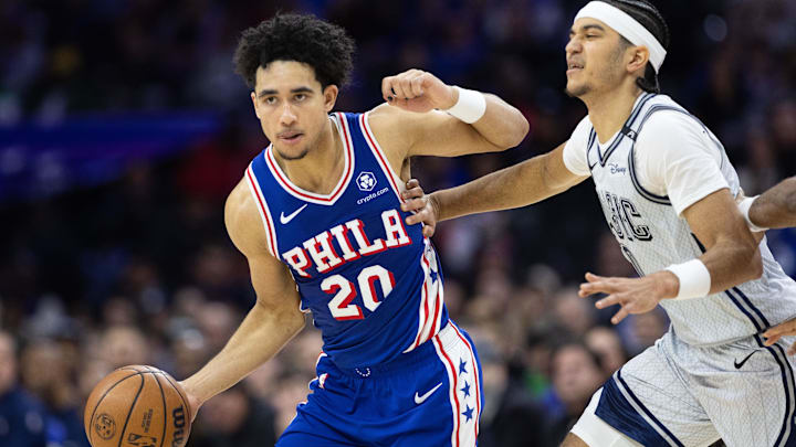 Dec 4, 2024; Philadelphia, Pennsylvania, USA; Philadelphia 76ers guard Jared McCain (20) dribbles past Orlando Magic guard Anthony Black (0) during the fourth quarter at Wells Fargo Center. Mandatory Credit: Bill Streicher-Imagn Images