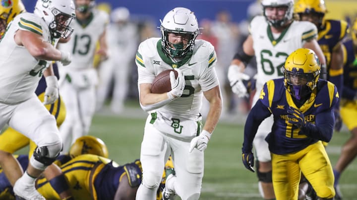 Nov 16, 2024; Morgantown, West Virginia, USA; Baylor Bears running back Dawson Pendergrass (35) runs the ball for a touchdown during the fourth quarter against the West Virginia Mountaineers at Mountaineer Field at Milan Puskar Stadium. Mandatory Credit: Ben Queen-Imagn Images