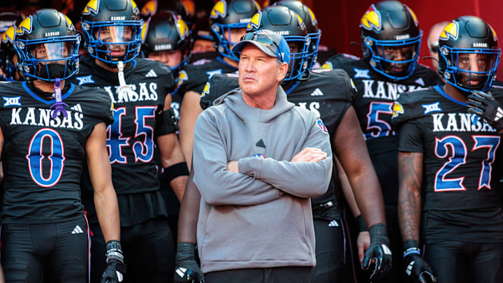 Nov 9, 2024; Kansas City, Missouri, USA; Kansas Jayhawks coach Lance Leipold leads the team onto the field for the game against the Iowa State Cyclones at GEHA Field at Arrowhead Stadium. Mandatory Credit: William Purnell-Imagn Images