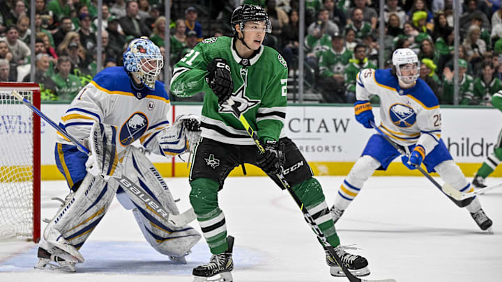 Apr 9, 2024; Dallas, Texas, USA; Dallas Stars left wing Jason Robertson (21) looks for the puck in front of Buffalo Sabres goaltender Ukko-Pekka Luukkonen (1) during the second period at the American Airlines Center. Mandatory Credit: Jerome Miron-Imagn Images