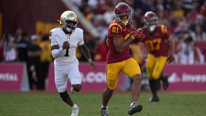USC Trojans wide receiver Kyle Ford (81) carries the ball against Notre Dame Fighting Irish safety Jordan Clark (1) in the second half