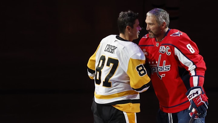Pittsburgh Penguins' Sidney Crosby  and Washington Capitals' Alex Ovechkin shake hands after a puck drop ceremony.