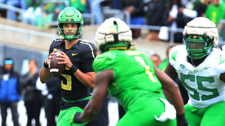 Oregon White Team quarterback Dante Moore, left, drops back to pass during the second quarter of the Spring Game at Autzen Stadium Saturday, April 27, 2024.