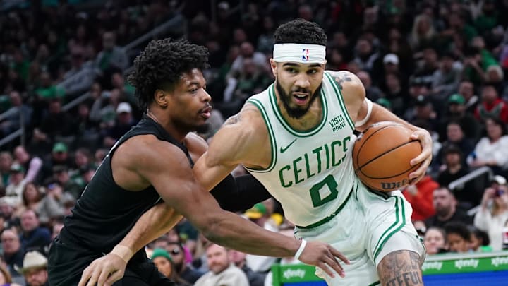 Feb 14, 2024; Boston, Massachusetts, USA; Boston Celtics forward Jayson Tatum (0) drives the ball against Brooklyn Nets guard Dennis Smith Jr. (4) in the first half at TD Garden. Mandatory Credit: David Butler II-Imagn Images