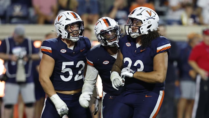 Sep 20, 2025; Charlottesville, Virginia, USA; Virginia Cavaliers defensive lineman Jacob Holmes (23) celebrates with teammates after recording a sack against the Stanford Cardinal during the third quarter at Scott Stadium. Mandatory Credit: Geoff Burke-Imagn Images Sep 20, 2025; Charlottesville, Virginia, USA; Virginia Cavaliers defensive lineman Jacob Holmes (23) celebrates with teammates after recording a sack against the Stanford Cardinal during the third quarter at Scott Stadium. Mandatory Credit: Geoff Burke-Imagn Images