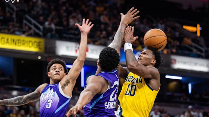 Apr 4, 2025; Indianapolis, Indiana, USA; Indiana Pacers guard Bennedict Mathurin (00) shoots the ball while Utah Jazz guard Keyonte George (3) and forward Brice Sensabaugh (28) defend in the second half at Gainbridge Fieldhouse. Mandatory Credit: Trevor Ruszkowski-Imagn Images