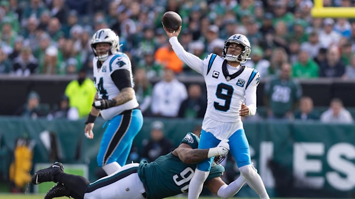Dec 8, 2024; Philadelphia, Pennsylvania, USA;  Carolina Panthers quarterback Bryce Young (9) passes the ball while being hit by Philadelphia Eagles defensive tackle Jalen Carter (98) during the first quarter at Lincoln Financial Field. Mandatory Credit: Bill Streicher-Imagn Images