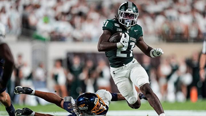 Michigan State running back Marvis Parrish (21) runs for s first down against Toledo safety Kaleb Hutchinson (17) during the first half at Spartan Stadium in East Lansing on Friday, Sept. 4, 2026. Michigan State running back Marvis Parrish (21) runs for s first down against Toledo safety Kaleb Hutchinson (17) during the first half at Spartan Stadium in East Lansing on Friday, Sept. 4, 2026.