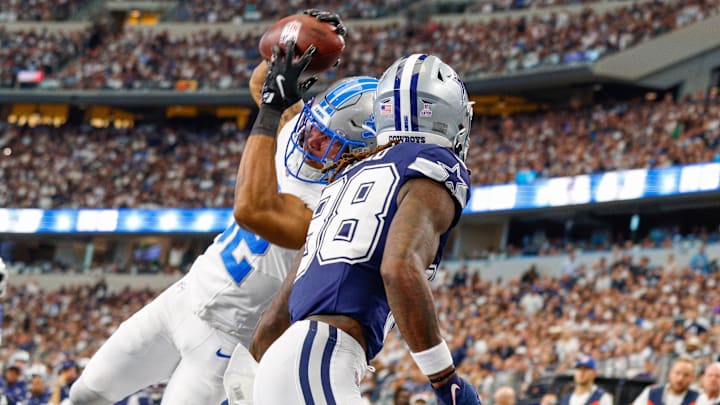 Oct 13, 2024; Arlington, Texas, USA; Detroit Lions safety Brian Branch (32) intercepts the ball in the endzone on a pass meant for Dallas Cowboys wide receiver CeeDee Lamb (88) during the first quarter at AT&T Stadium.