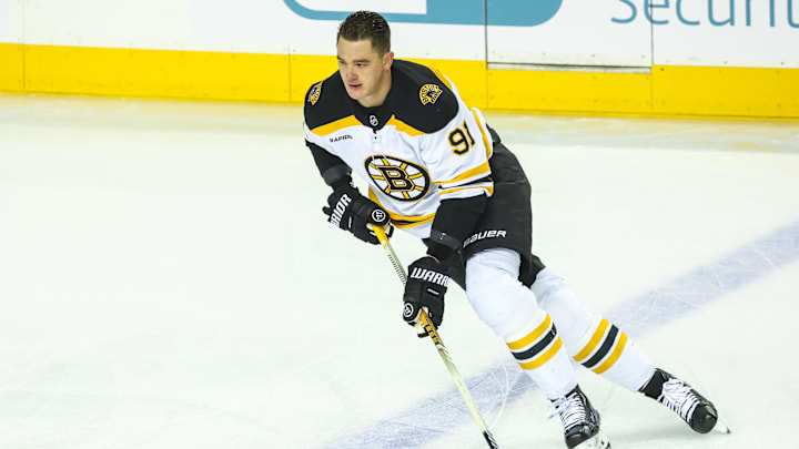 Dec 17, 2024; Calgary, Alberta, CAN; Boston Bruins defenseman Nikita Zadorov (91) skates with the puck during the warmup period against the Calgary Flames at Scotiabank Saddledome. Mandatory Credit: Sergei Belski-Imagn Images