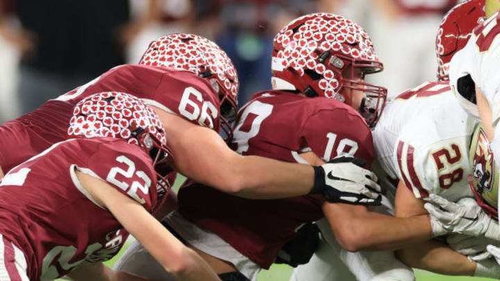 Maple Grove defenders make a tackle against Lakeville South