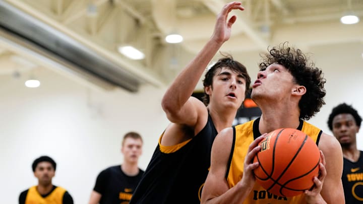 Iowa’s Isaia Howard (23) looks to shoot as Tate Sage (24) defends during practice June 19, 2025 at Carver-Hawkeye Arena in Iowa City, Iowa.