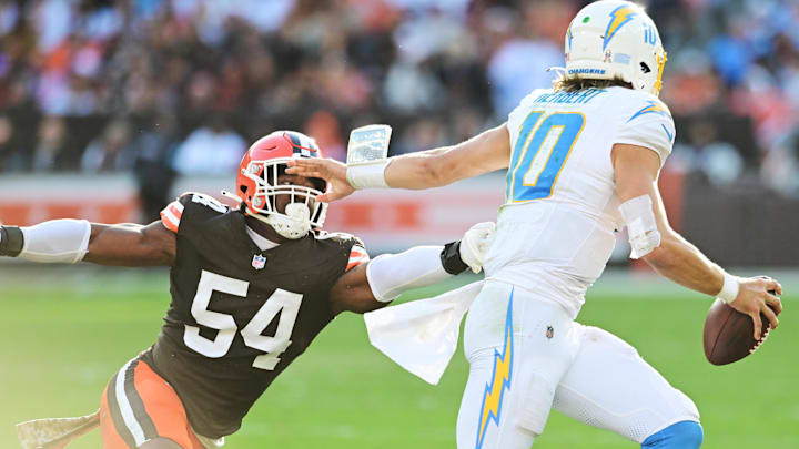 Nov 3, 2024; Cleveland, Ohio, USA; Cleveland Browns defensive end Ogbo Okoronkwo (54) chases Los Angeles Chargers quarterback Justin Herbert (10) during the second half at Huntington Bank Field.