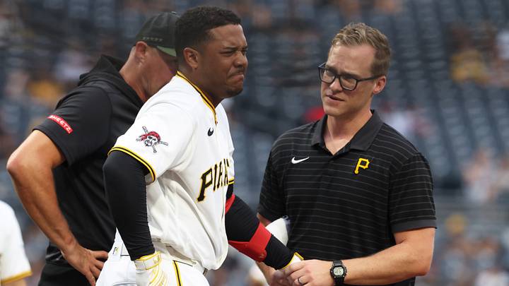 Pittsburgh Pirates right fielder Esmerlyn Valdez grimaces as trainer Joel Harris attends to an apparent injury. Pittsburgh Pirates right fielder Esmerlyn Valdez grimaces as trainer Joel Harris attends to an apparent injury.