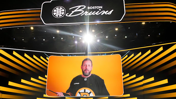 Jun 27, 2025; Los Angeles, California, USA; Adam Sandler announces the seventh overall pick for the Boston Bruins in the first round of the 2025 NHL Draft at Peacock Theater. Mandatory Credit: Kirby Lee-Imagn Images