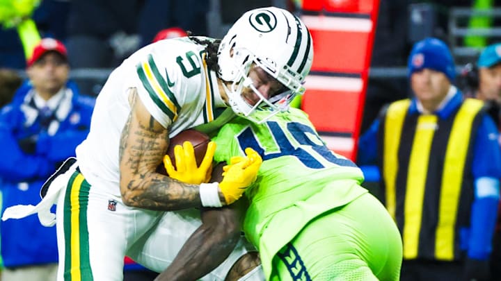 Dec 15, 2024; Seattle, Washington, USA; Seattle Seahawks linebacker Tyrice Knight (48) tackles Green Bay Packers wide receiver Christian Watson (9) following a reception by Watson during the third quarter at Lumen Field.