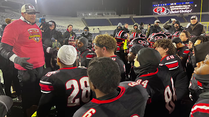 Quince Orchard head coach John Kelley speaks with his squad after it defeated Wise for their second straight Maryland Class 4A state championship.