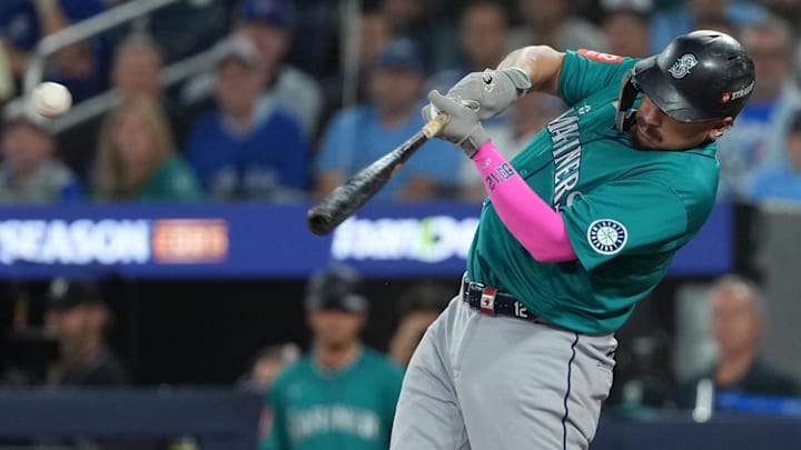 Oct 19, 2025; Toronto, Ontario, CAN; Seattle Mariners first baseman Josh Naylor (12) singles in the fourth inning against the Toronto Blue Jays during game six of the ALCS round for the 2025 MLB playoffs at Rogers Centre. Mandatory Credit: Nick Turchiaro-Imagn Images