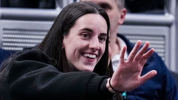 Indiana Fever guard Caitlin Clark (22) waves to her former teammates Wednesday, March 5, 2025, in a round one game at the 2025 TIAA Big Ten Women's Basketball Tournament between the Iowa Hawkeyes and the Wisconsin Badgers at Gainbridge Fieldhouse in Indianapolis.