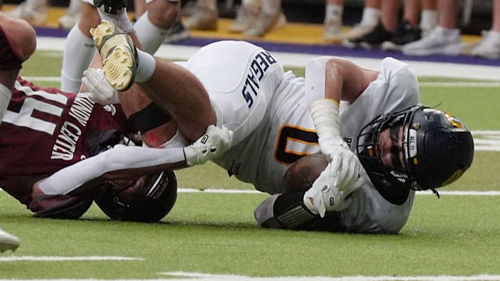 Regina's tight end Tate Wallace (0) gets tackle by Grundy Center's wide receiver/defensive back Eli Wegmann (4) after making a catch for a first down during the second quarter in the 1A High School state semi-final on Nov. 14, 2025, at UNI-Dome in Cedar Falls, Iowa. Regina's tight end Tate Wallace (0) gets tackle by Grundy Center's wide receiver/defensive back Eli Wegmann (4) after making a catch for a first down during the second quarter in the 1A High School state semi-final on Nov. 14, 2025, at UNI-Dome in Cedar Falls, Iowa.
