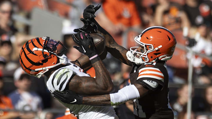 Oct 20, 2024; Cleveland, Ohio, USA; Cleveland Browns cornerback Denzel Ward (21) breaks up a pass intended for Cincinnati Bengals wide receiver Tee Higgins (5) during the fourth quarter at Huntington Bank Field.
