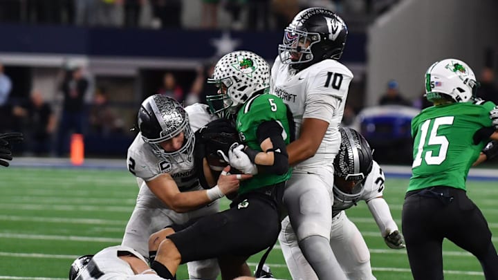 A swarm of Austin Vandegrift defenders tackle Southlake Carroll's Blake Gunter during the 6A DII UIL Texas State Football Championship game on Saturday, December 21, 2024 at AT&T Stadium in Arlington.