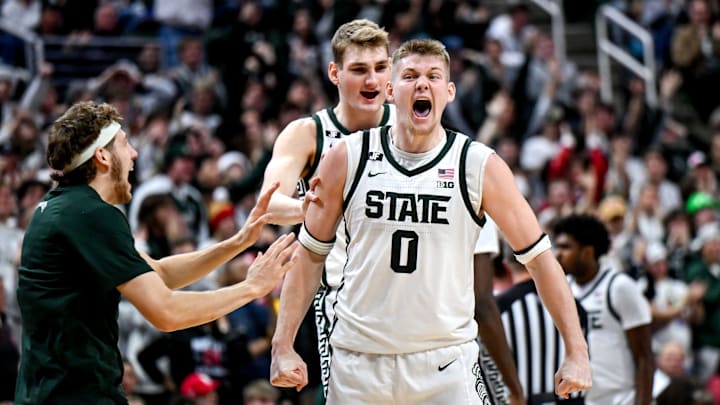 Michigan State's Jaxon Kohler, right, celebrates with teammates Carson Cooper, center, and Gehrig Normand, left, after a MSU score and Nebraska timeout during the second half on Saturday, Dec. 7, 2024, at the Breslin Center in East Lansing.