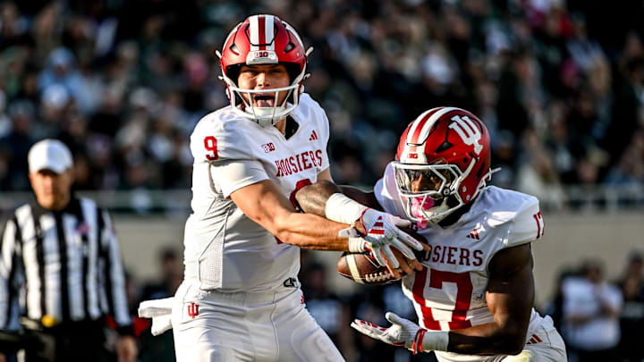 Indiana's Kurtis Rourke, left, hands the ball off to Ty Son Lawton during the second quarter on Saturday, Nov. 2, 2024, at Spartan Stadium in East Lansing.