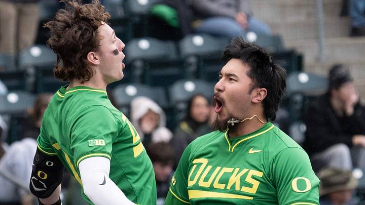 Oregon’s Dominic Hellman, right, celebrates his three RPI home run with teammate Drew Smith, left, during the second inning of their baseball game against George Mason Feb. 13, 2026 at PK Park in Eugene.