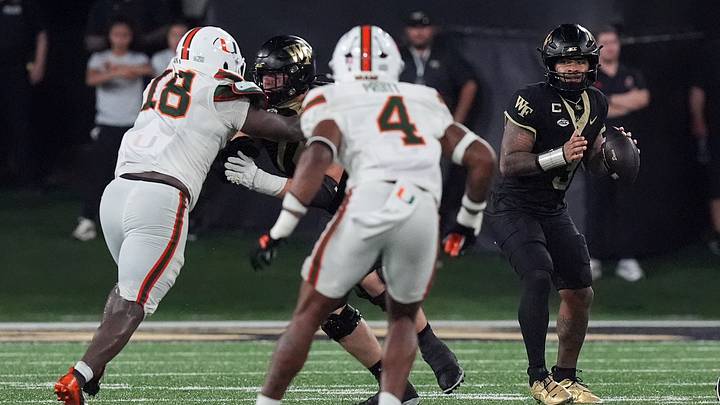 Sep 18, 2026; Winston-Salem, North Carolina, USA;  Wake Forest Demon Deacons quarterback Gio Lopez (3) looks to pass pressured by Miami (FL) Hurricanes defensive lineman Armondo Blount (18) and  linebacker Cameron Pruitt (4) during the second half at Allegacy Federal Credit Union Stadium.  Mandatory Credit: Jim Dedmon-Imagn Images