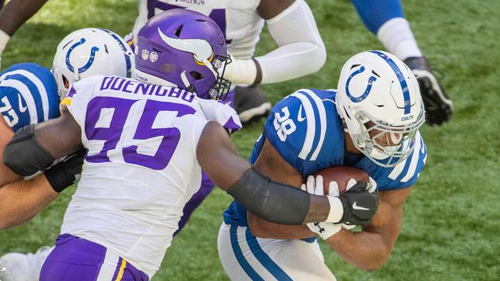 Sep 20, 2020; Indianapolis, Indiana, USA; Indianapolis Colts running back Jonathan Taylor (28) runs the ball while Minnesota Vikings defensive end Ifeadi Odenigbo (95) defends in the first quarter at Lucas Oil Stadium. Mandatory Credit: Trevor Ruszkowski-Imagn Images