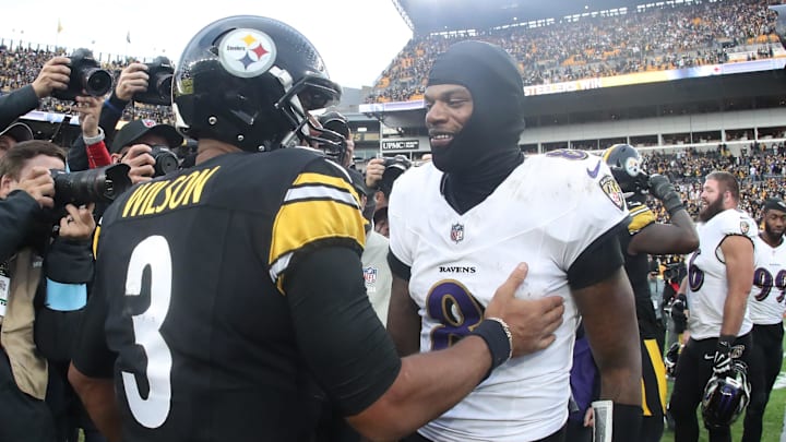 Nov 17, 2024; Pittsburgh, Pennsylvania, USA;  Pittsburgh Steelers quarterback Russell Wilson (3) and Baltimore Ravens quarterback Lamar Jackson (8) meet at mid-field after playing at Acrisure Stadium. Mandatory Credit: Charles LeClaire-Imagn Images