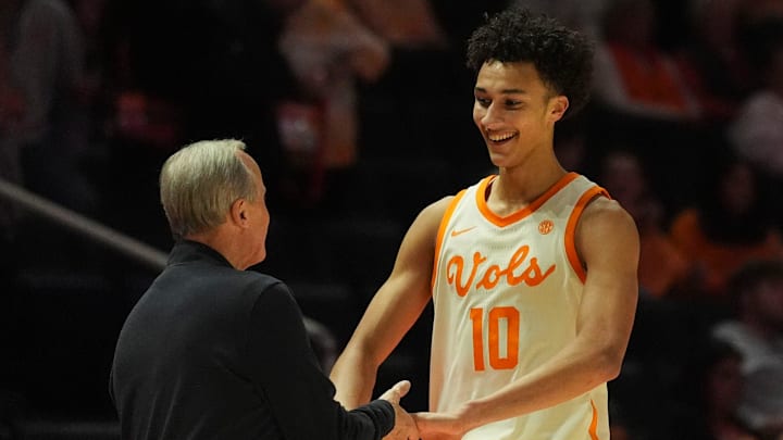 Tennessee forward Nate Ament (10) returns a smile to Tennessee basketball coach Rick Barnes as he comes off the court in the final minutes of the NCAA college basketball game against Ole Miss on February 3, 2026, in Knoxville, Tennessee.