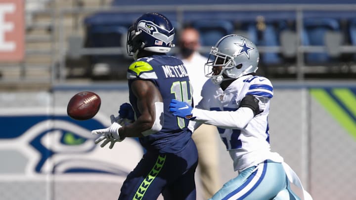 Sep 27, 2020; Seattle, Washington, USA; Dallas Cowboys cornerback Trevon Diggs (27) forces a fumble by Seattle Seahawks wide receiver DK Metcalf (14) during the first quarter at CenturyLink Field. Mandatory Credit: Joe Nicholson-Imagn Images