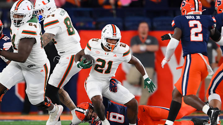Nov 30, 2024; Syracuse, New York, USA; Syracuse Orange defensive back Justin Barron (8) tackles Miami Hurricanes running back Jordan Lyle (21) during the first half at the JMA Wireless Dome. Mandatory Credit: Rich Barnes-Imagn Images Nov 30, 2024; Syracuse, New York, USA; Syracuse Orange defensive back Justin Barron (8) tackles Miami Hurricanes running back Jordan Lyle (21) during the first half at the JMA Wireless Dome. Mandatory Credit: Rich Barnes-Imagn Images