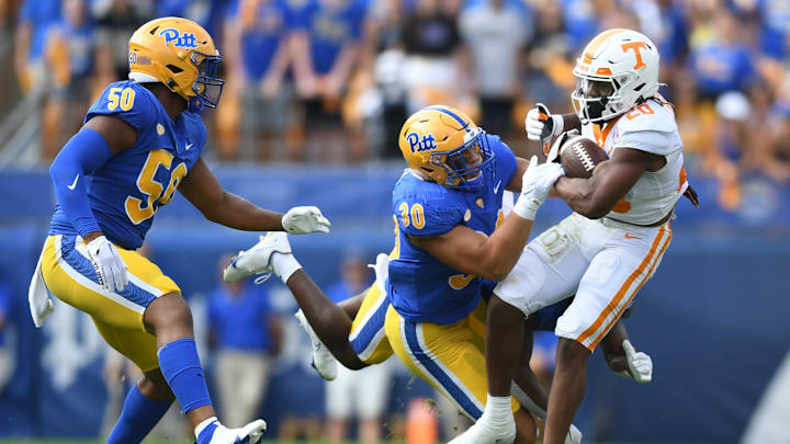 Tennessee running back Jaylen Wright (20) is tackled by Pittsburgh linebacker Brandon George (30)