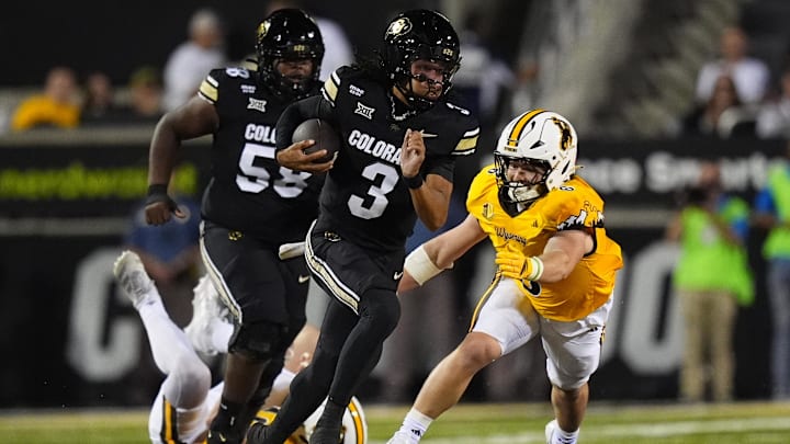 Sep 20, 2025; Boulder, Colorado, USA; Colorado Buffaloes quarterback Kaidon Salter (3) scrambles with the ball as Wyoming Cowboys linebacker Evan Eller (6) chases in first quarter at Folsom Field. Mandatory Credit: Ron Chenoy-Imagn Images
