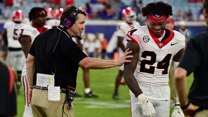 Georgia Bulldogs co-defensive coordinator and former Gator head coach Will Muschamp shares a smile with Georgia Bulldogs defensive back Malaki Starks (24) as the clock ticks down on Georgia's lopsided victory over the Gators at the annual Florida vs Georgia football game at EverBank Stadium in Jacksonville, FL, Saturday, October 27, 2023. Georgia walked away with a final score of 43 to 20. [Bob Self/Florida Times-Union]