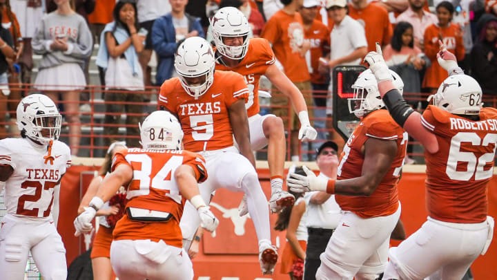 The Texas Orange team celebrate a touchdown catch by wide receiver Ryan Wingo (5) in the fourth quarter of the Longhorns' spring Orange and White game at Darrell K Royal Texas Memorial Stadium in Austin, Texas, April 20, 2024. The Texas Orange team celebrate a touchdown catch by wide receiver Ryan Wingo (5) in the fourth quarter of the Longhorns' spring Orange and White game at Darrell K Royal Texas Memorial Stadium in Austin, Texas, April 20, 2024.