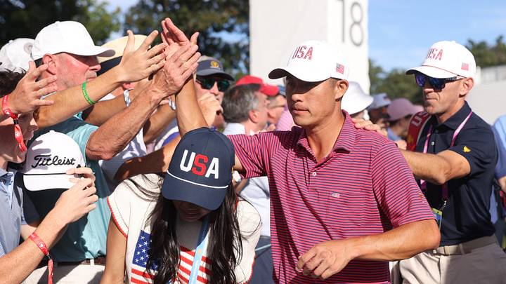 Collin Morikawa exchanges high-fives with U.S. fans after a comeback victory in the Presidents Cup Collin Morikawa exchanges high-fives with U.S. fans after a comeback victory in the Presidents Cup