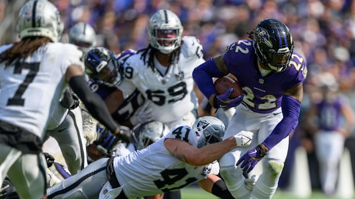 Sep 15, 2024; Baltimore, Maryland, USA; Baltimore Ravens running back Derrick Henry (22) runs the ball while being tackled by Las Vegas Raiders linebacker Robert Spillane (41) during the second half at M&T Bank Stadium. Mandatory Credit: Reggie Hildred-Imagn Images