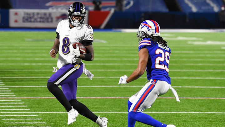Jan 16, 2021; Orchard Park, New York, USA; Baltimore Ravens quarterback Lamar Jackson (8) runs with the ball as Buffalo Bills cornerback Josh Norman (29) defends during the third quarter of an AFC Divisional Round game at Bills Stadium. Mandatory Credit: Rich Barnes-Imagn Images