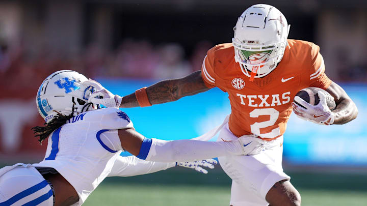 Texas Longhorns wide receiver Matthew Golden (2) stiff arms Kentucky Wildcats defensive back Maxwell Hairston (1) in the first quarter of an NCAA college football game at Darrell K Royal Texas Memorial Stadium in Austin, Texas on Saturday, Nov. 24, 2024.